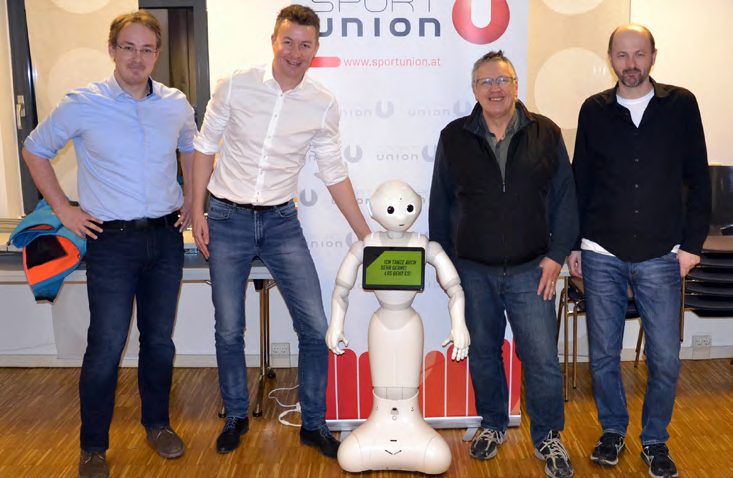 4 men and a robot in the centre